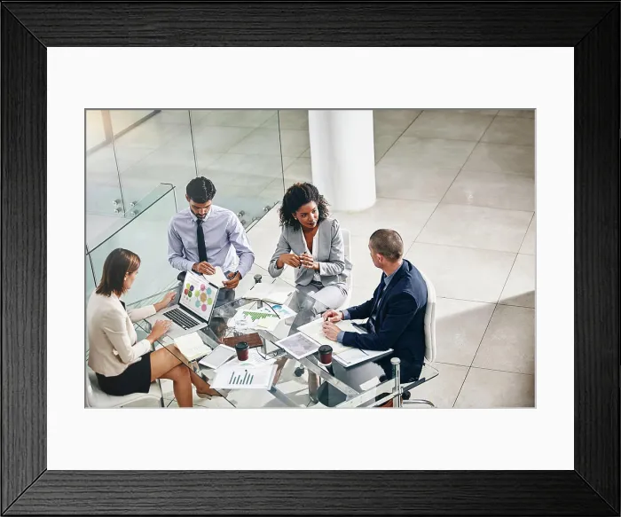 Framed Print : Group, business people and manager with laptop on desk for financial meeting Framed Print : Group, business people and manager with laptop on desk for financial meeting
