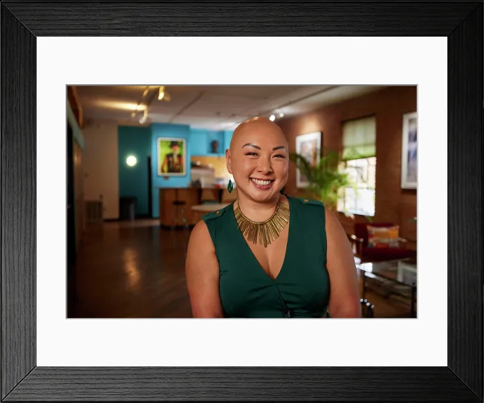 Framed Print : Bald businesswoman with a bright smile in her creative workspace