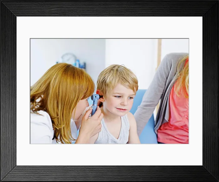 Framed Print : Doctor examining a child's ear Framed Print : Doctor examining a child's ear