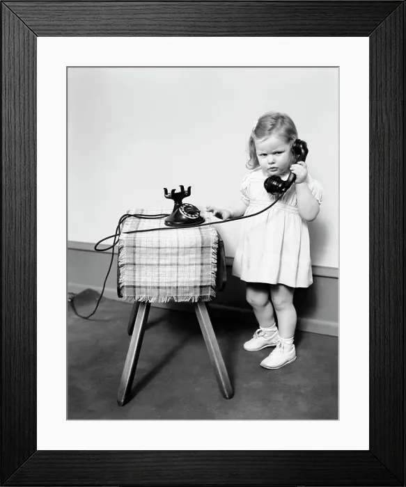 Framed Print : 1930S 1940S Unhappy Frowing Little Girl Takling On Old Black Rotary Dial Telephone