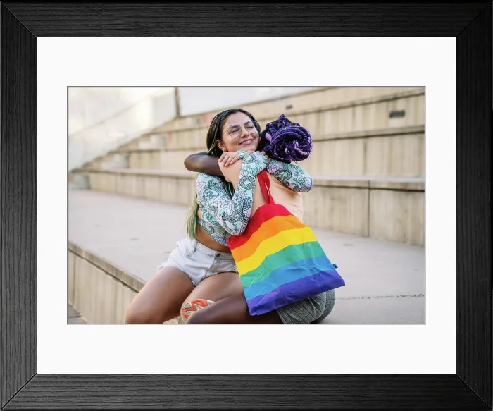 Framed Print : Happy interracial lesbian couple embracing Framed Print : Happy interracial lesbian couple embracing