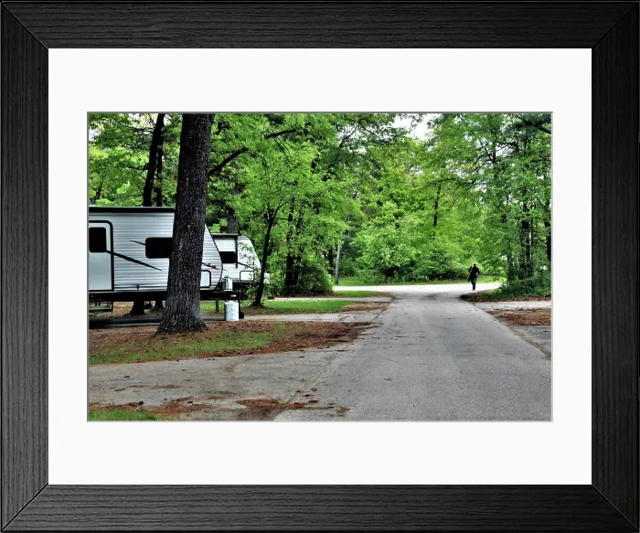 Framed Print : A camper is set up at a campsite May 26