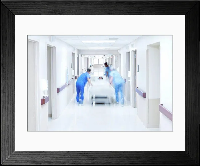 Framed Print : Medical team pushing patient on bed