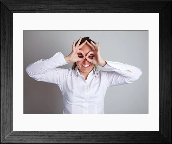 Framed Print : Happy business woman making circles with her fingers around her eyes Framed Print : Happy business woman making circles with her fingers around her eyes