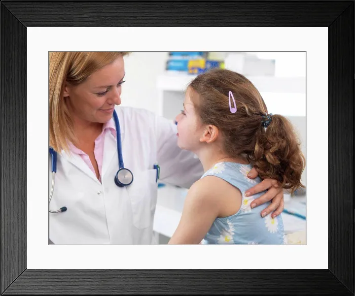 Framed Print : Doctor comforting a 5 year old girl in a clinic Framed Print : Doctor comforting a 5 year old girl in a clinic