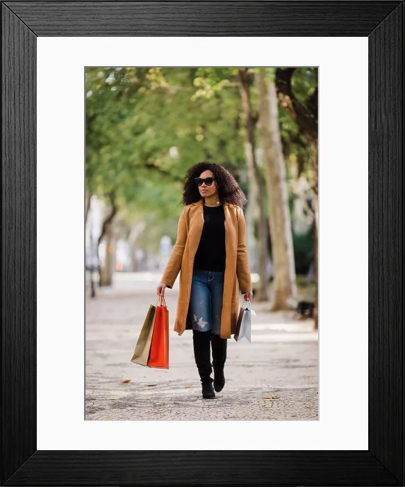 Framed Print : Stylish young woman walking with shopping bags on sidewalk Framed Print : Stylish young woman walking with shopping bags on sidewalk