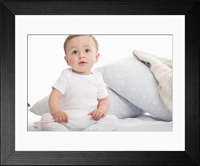 Framed Print : Baby sitting on couch Framed Print : Baby sitting on couch