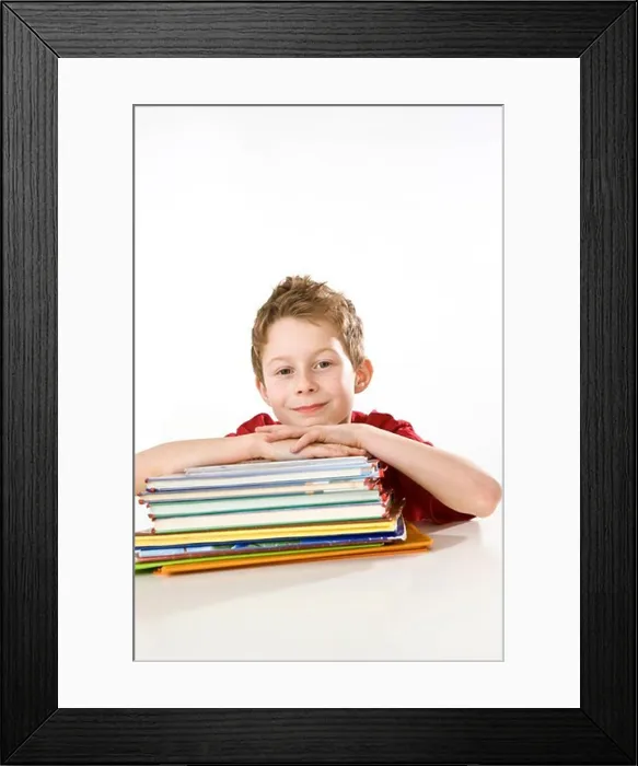 Framed Print : Boy leaning on books and smiling Framed Print : Boy leaning on books and smiling
