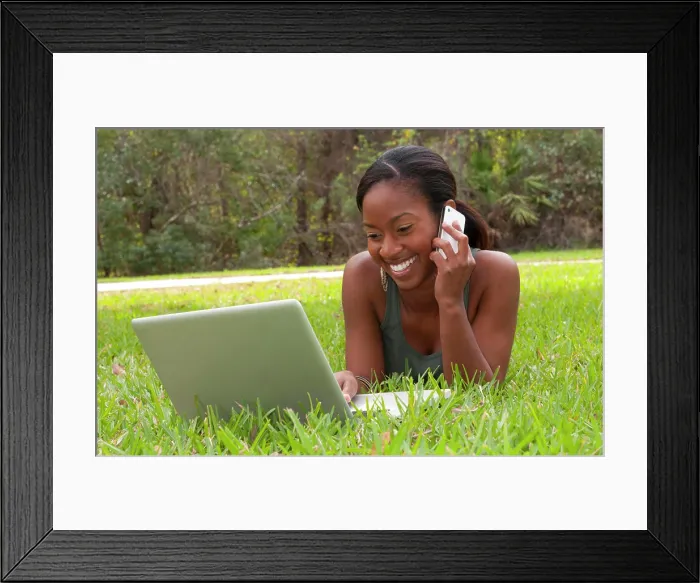 Framed Print : Black African American teen girl age 18 working on computer Facebook with emailing friends cell phone in front yard Framed Print : Black African American teen girl age 18 working on computer Facebook with emailing friends cell phone in front yard