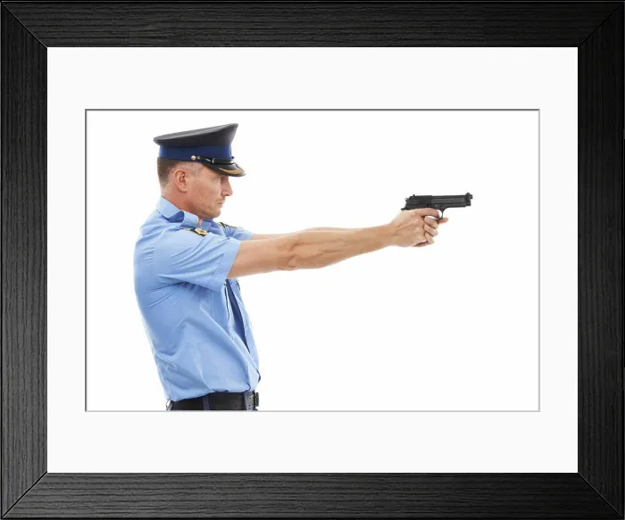 Framed Print : Man, police officer and pointing gun ready to fire or shoot standing isolated on a white studio background Framed Print : Man, police officer and pointing gun ready to fire or shoot standing isolated on a white studio background