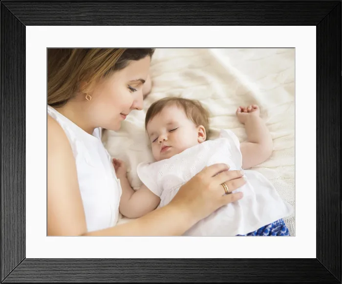 Framed Print : Young pretty woman with sleeping baby girl Framed Print : Young pretty woman with sleeping baby girl