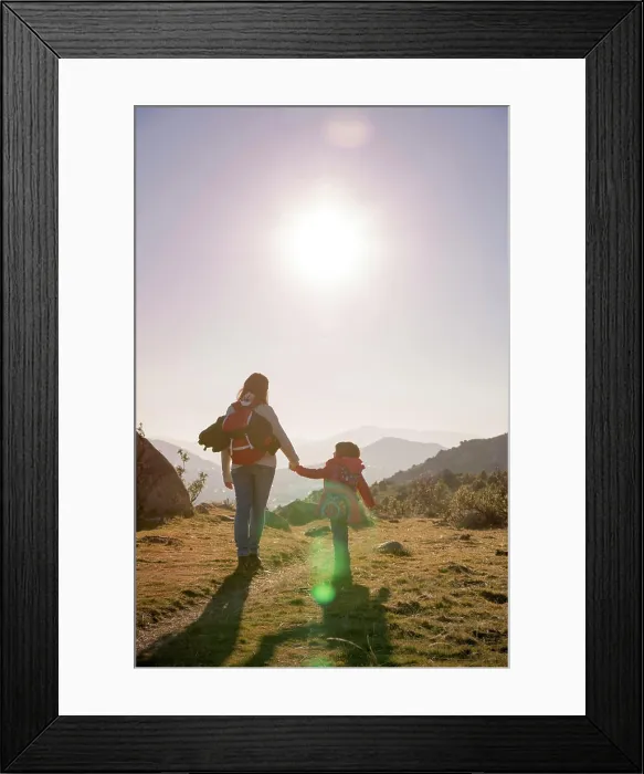 Framed Print : Mom keeps daughter's hand and walks on the nature in sunset light Framed Print : Mom keeps daughter's hand and walks on the nature in sunset light