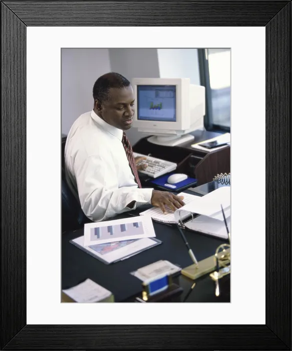 Framed Print : Side profile of a businessman working in an office Framed Print : Side profile of a businessman working in an office