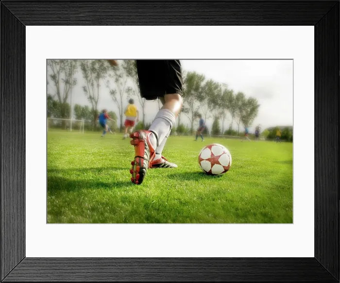 Framed Print : Young Soccer Player About To Kick Ball