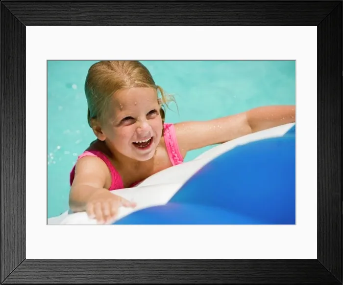 Framed Print : Close-up of a cheerful girl looking up at swimming pool Framed Print : Close-up of a cheerful girl looking up at swimming pool