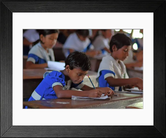 Framed Print : BANGLADESH, Jessore. Schoolgirls wearing their blue school uniform, sitting at their desk and studying conscientiously Framed Print : BANGLADESH, Jessore. Schoolgirls wearing their blue school uniform, sitting at their desk and studying conscientiously