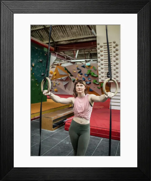 Framed Print : Young female rock climber training at gymnastics rings Framed Print : Young female rock climber training at gymnastics rings