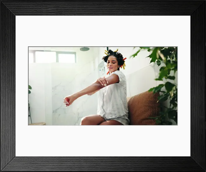 Framed Print : Skincare, bathroom and woman apply body cream for self care Framed Print : Skincare, bathroom and woman apply body cream for self care