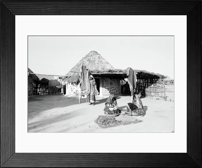 Framed Print : Women in front of round shaped homes bhungas embroidering fabrics