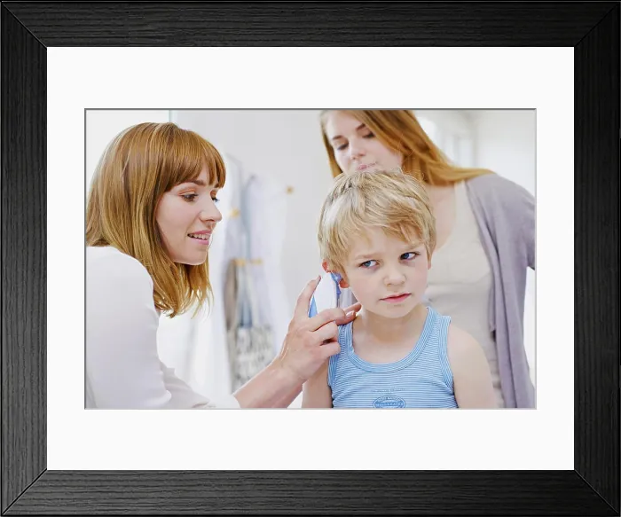 Framed Print : Doctor measuring a child's temperature Framed Print : Doctor measuring a child's temperature