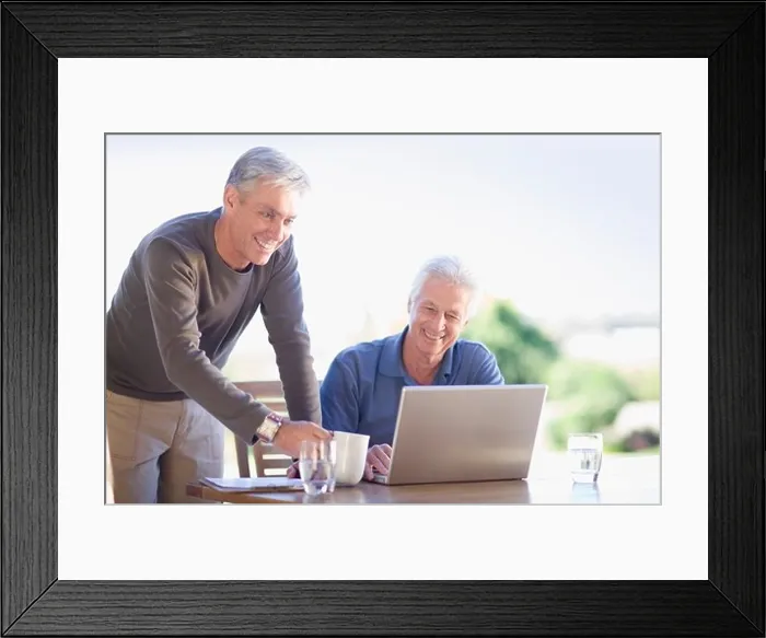 Framed Print : Older men using laptop together Framed Print : Older men using laptop together
