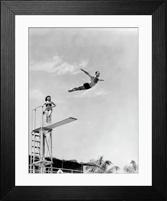 Framed Print : 1940S Man Swan Diving Off High Diving Board Woman Watching Framed Print : 1940S Man Swan Diving Off High Diving Board Woman Watching