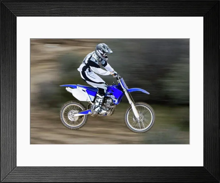 Framed Print : Catching air on a motorcross bike (motion blur)