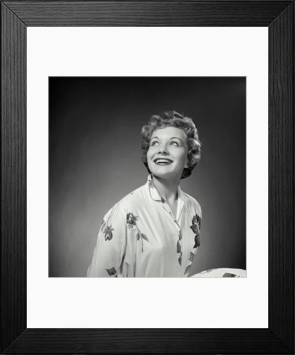 Framed Print : Vintage Photograph. Woman poses for studio portrait she looks to the top left of frame and smiles big Framed Print : Vintage Photograph. Woman poses for studio portrait she looks to the top left of frame and smiles big