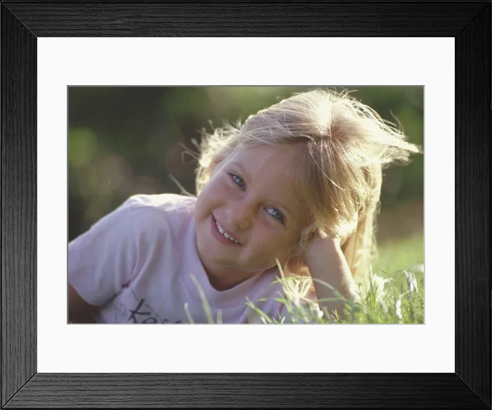 Framed Print : Hawaii closeup smiling girl lay in grass, blonde hair backlit Framed Print : Hawaii closeup smiling girl lay in grass, blonde hair backlit