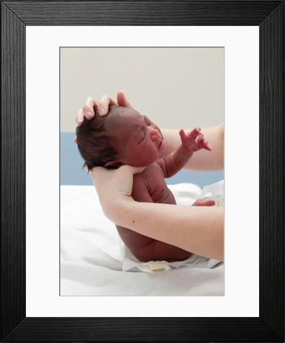 Framed Print : The pediatrician checks the bones of the skull and the appearance of the fontanelles Framed Print : The pediatrician checks the bones of the skull and the appearance of the fontanelles