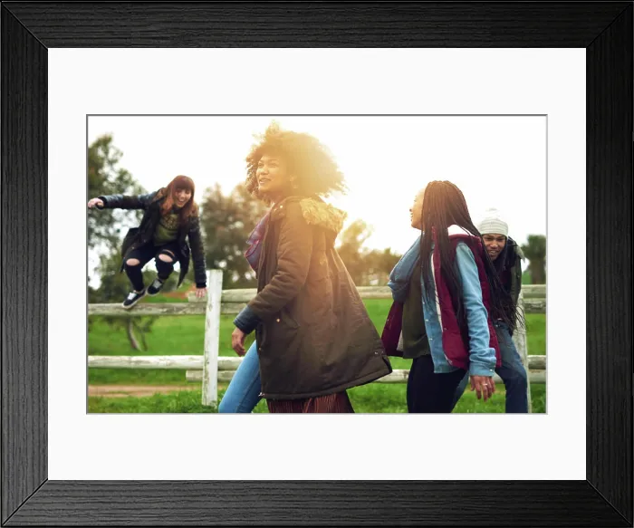 Framed Print : Happy people, friends and jumping with fence on grass field for summer fun