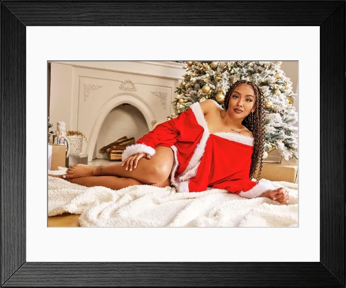 Framed Print : Woman in red Santa dress posing by flocked Christmas tree with gold ornaments and fireplace Framed Print : Woman in red Santa dress posing by flocked Christmas tree with gold ornaments and fireplace