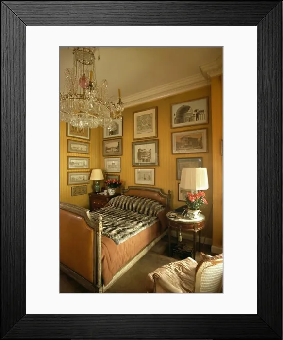 Framed Print : Antique glass chandelier above single bed with faux fur throw in bedroom with black Framed Print : Antique glass chandelier above single bed with faux fur throw in bedroom with black
