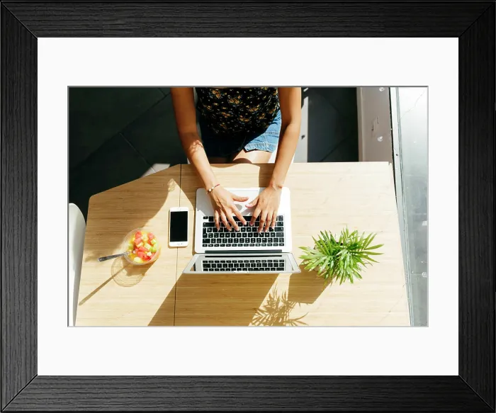 Framed Print : From above unrecognizable lady typing on laptop keyboard while sitting at table with healthy fruit salad Framed Print : From above unrecognizable lady typing on laptop keyboard while sitting at table with healthy fruit salad