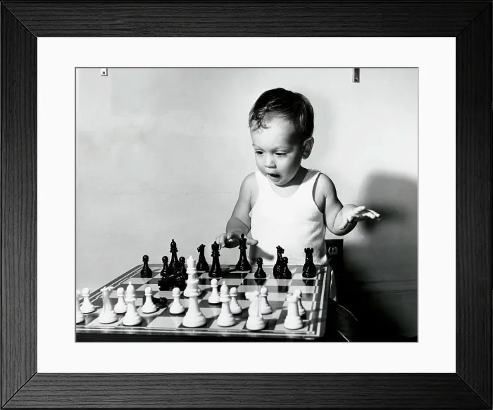 Framed Print : Close-up of a boy playing chess Framed Print : Close-up of a boy playing chess