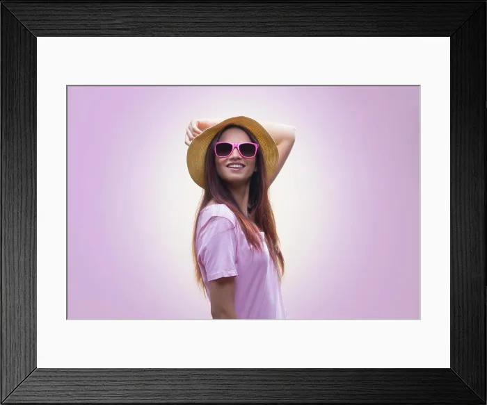 Framed Print : Portrait of young woman wearing hat and sunglasses