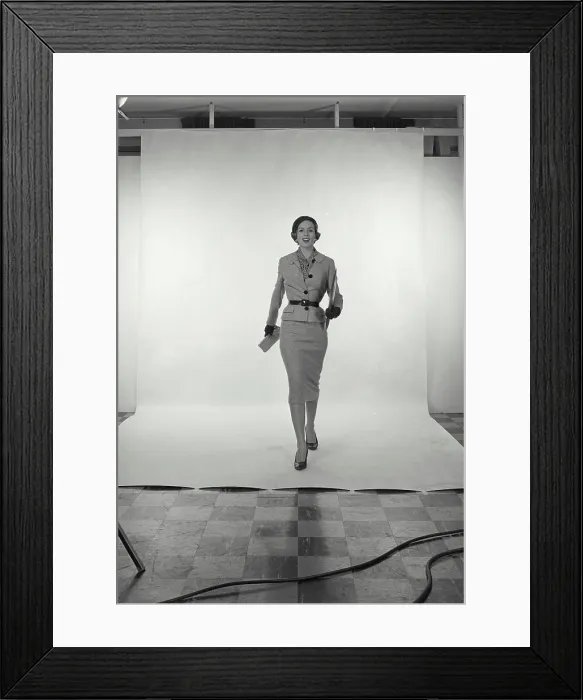 Framed Print : Vintage Photograph. Full length view of woman wearing light grey skirt and jacket and hat on white studio background Framed Print : Vintage Photograph. Full length view of woman wearing light grey skirt and jacket and hat on white studio background