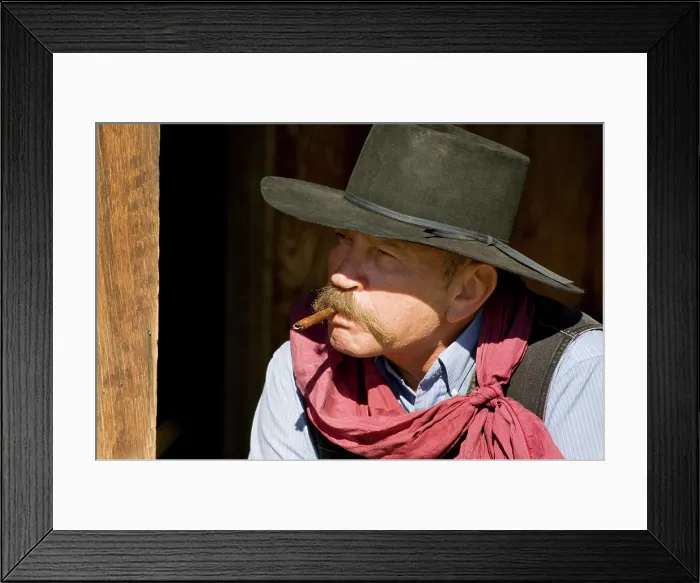 Framed Print : USA, Oregon, Seneca, Ponderosa Ranch. Portrait of a cowboy with cigar in mouth. (MR / PR) Framed Print : USA, Oregon, Seneca, Ponderosa Ranch. Portrait of a cowboy with cigar in mouth. (MR / PR)