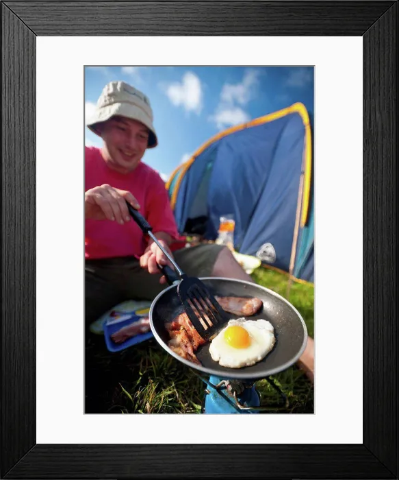 Framed Print : Man cooking fried breakfast of bacon and egg beside tent; Lulworth, Dorset, UK Framed Print : Man cooking fried breakfast of bacon and egg beside tent; Lulworth, Dorset, UK
