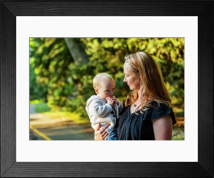 Framed Print : Mother spending quality time with her son who has Down Syndrome in a city park during an autumn day; Leduc Framed Print : Mother spending quality time with her son who has Down Syndrome in a city park during an autumn day; Leduc