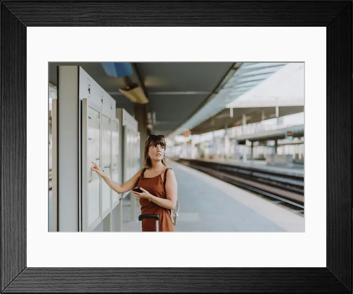 Framed Print : Tourist woman walking inside the train station in Antwerp