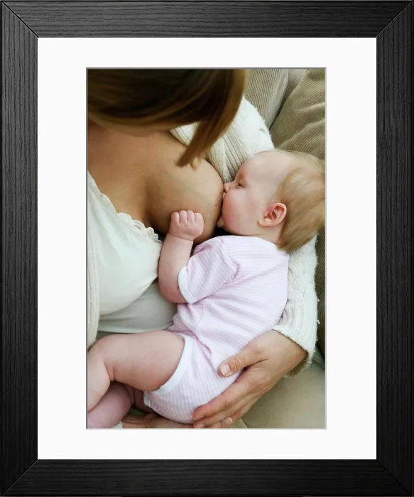 Framed Print : Close-up of a mid adult woman breastfeeding her daughter Framed Print : Close-up of a mid adult woman breastfeeding her daughter