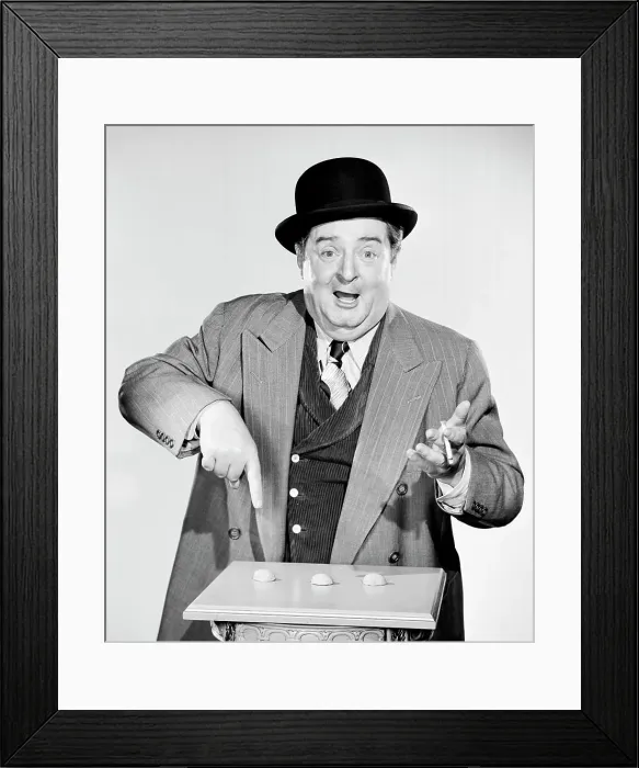 Framed Print : Portrait of a man pointing to nutshells Framed Print : Portrait of a man pointing to nutshells