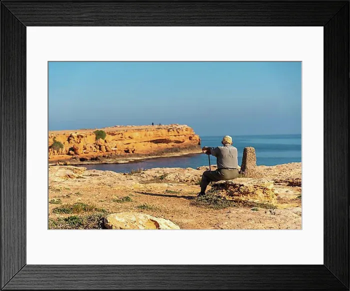 Framed Print : Pensive old man sitting on the shoreline by the sea. Traditional lord of Spanish culture Framed Print : Pensive old man sitting on the shoreline by the sea. Traditional lord of Spanish culture