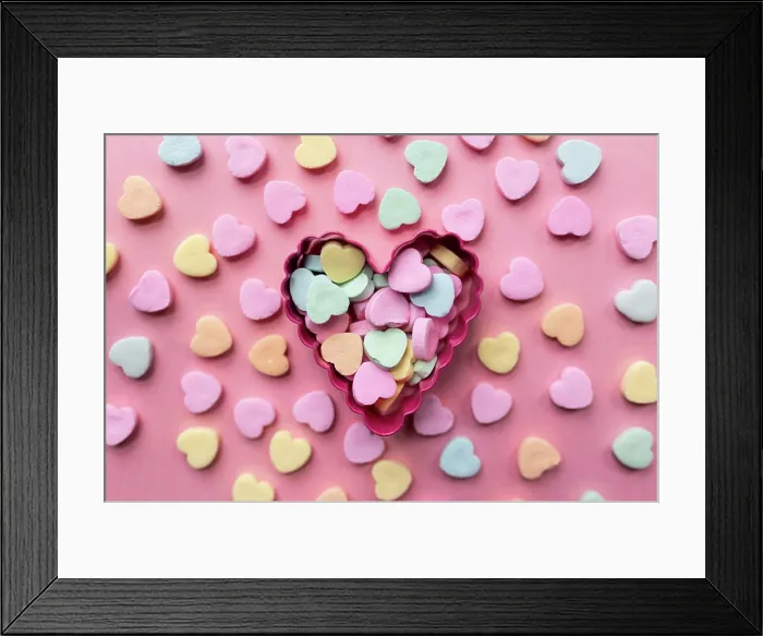 Framed Print : flat lay of a pile of candy hearts against a pink background Framed Print : flat lay of a pile of candy hearts against a pink background