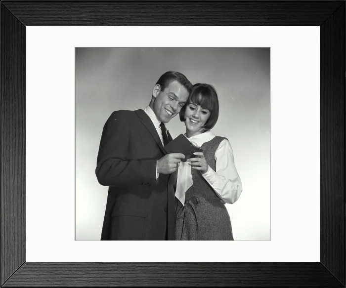 Framed Print : Vintage Photograph. A man and woman looking at bank book smiling Framed Print : Vintage Photograph. A man and woman looking at bank book smiling