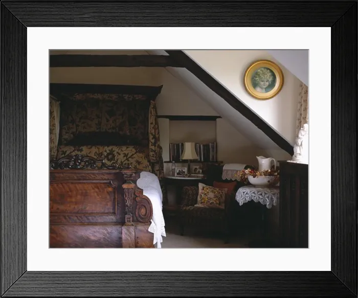 Framed Print : 19th-century carved half-tester bed with antique crewelwork hangings in attic country bedroom Framed Print : 19th-century carved half-tester bed with antique crewelwork hangings in attic country bedroom