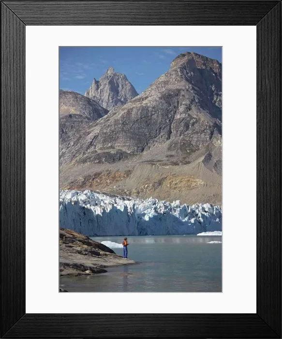 Framed Print : man standing at the water's edge of a fjord in Greenland Framed Print : man standing at the water's edge of a fjord in Greenland