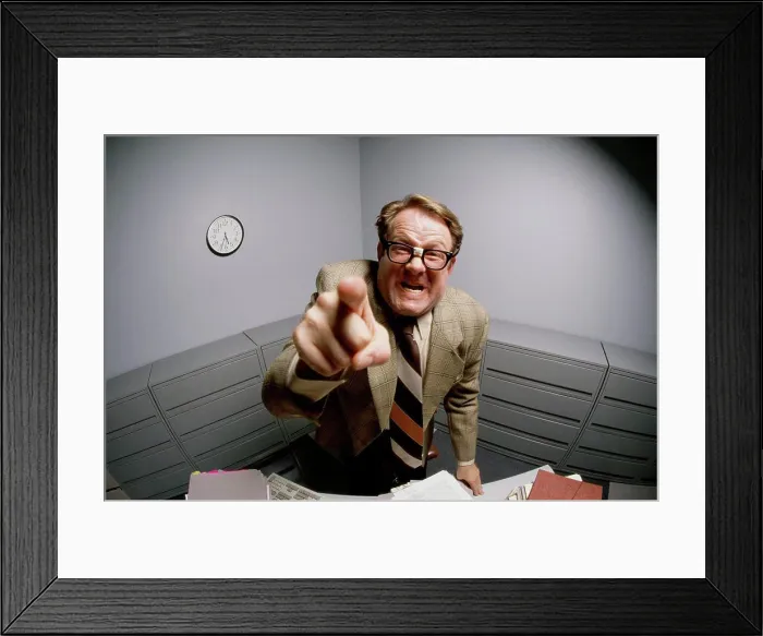 Framed Print : Portrait of a businessman pointing forward in anger Framed Print : Portrait of a businessman pointing forward in anger
