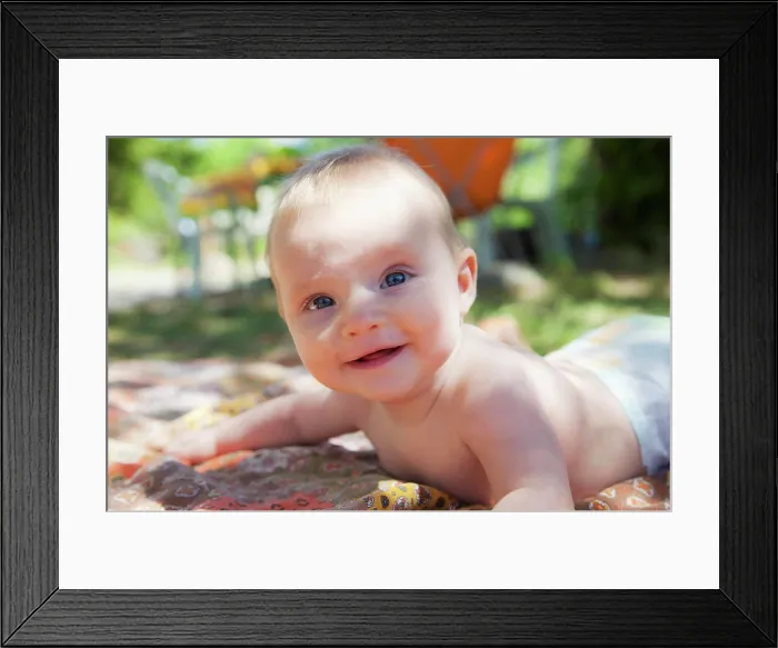 Framed Print : Smiling baby raised on his arms in the garden Framed Print : Smiling baby raised on his arms in the garden